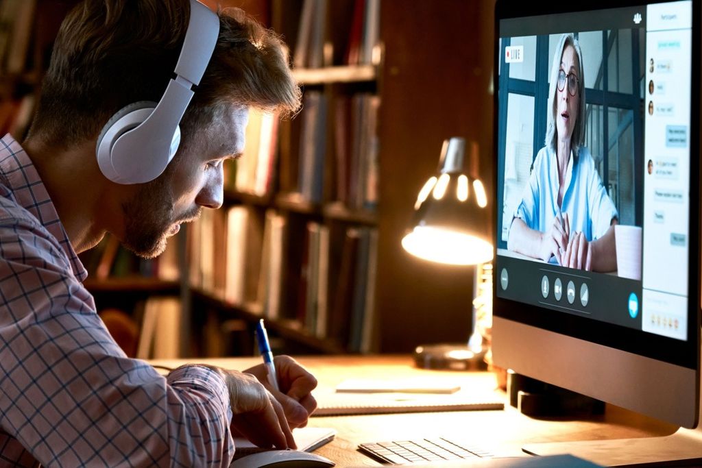 A man follows an online lecture